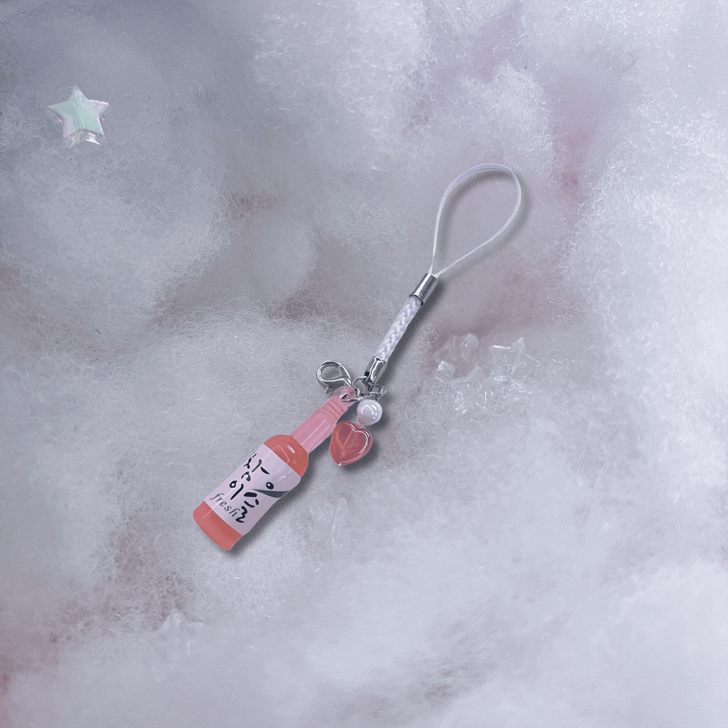 pink soju bottle with heart and white braided strap handmade phone charm, decorative strap accessory for phones and cases.
