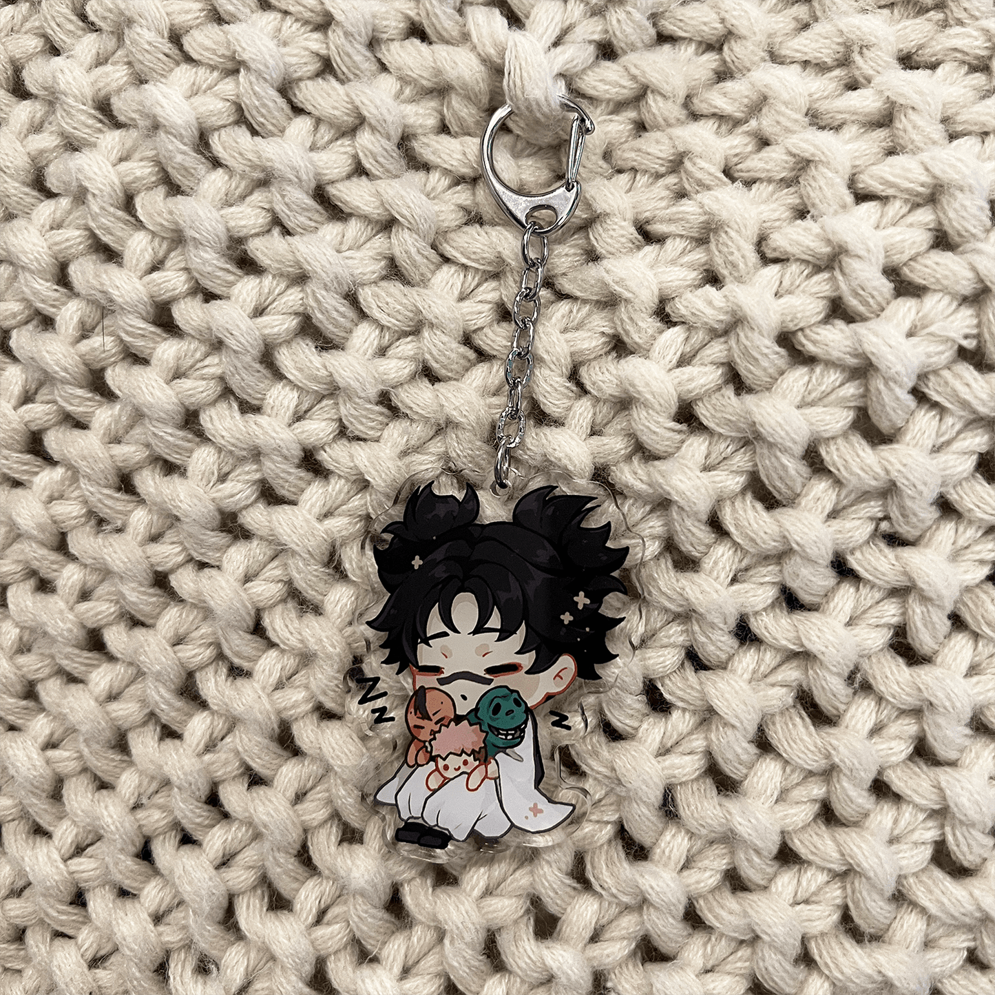 clear acrylic keychain featuring choso from jujutsu kaisen sleeping and holding his brothers