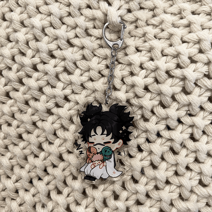 clear acrylic keychain featuring choso from jujutsu kaisen sleeping and holding his brothers