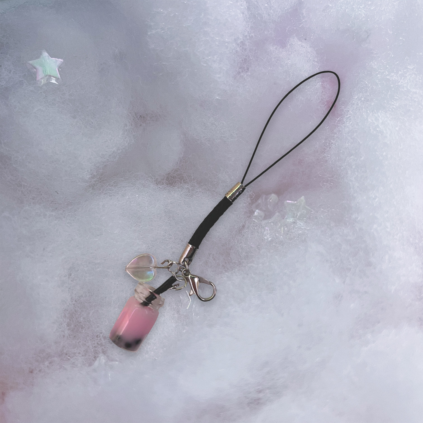 Pink boba charm with holographic heart charm and black braided phone strap.