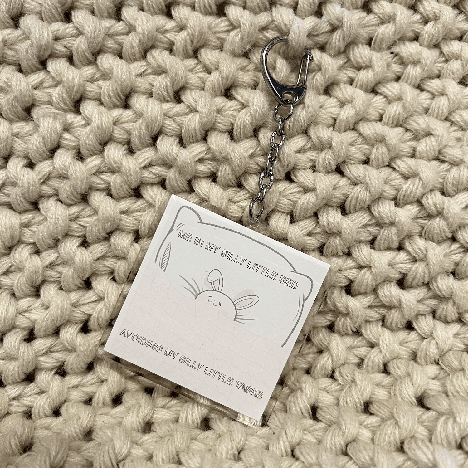 bunny in a bed kawaii acrylic keychain, lightweight charm for keys and bags.