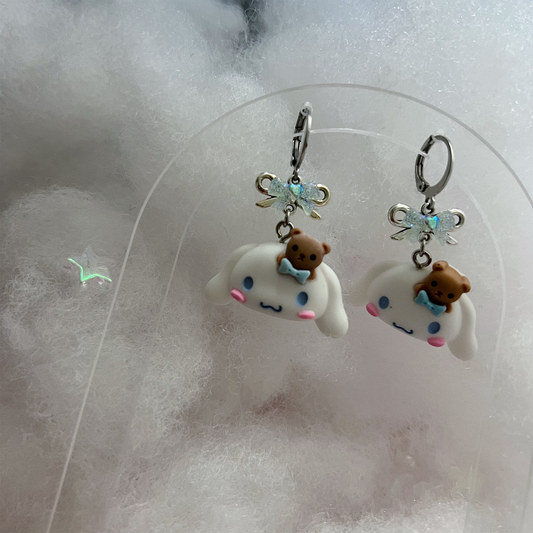 Cinnamoroll Earrings in a dreamy white cloud background.
