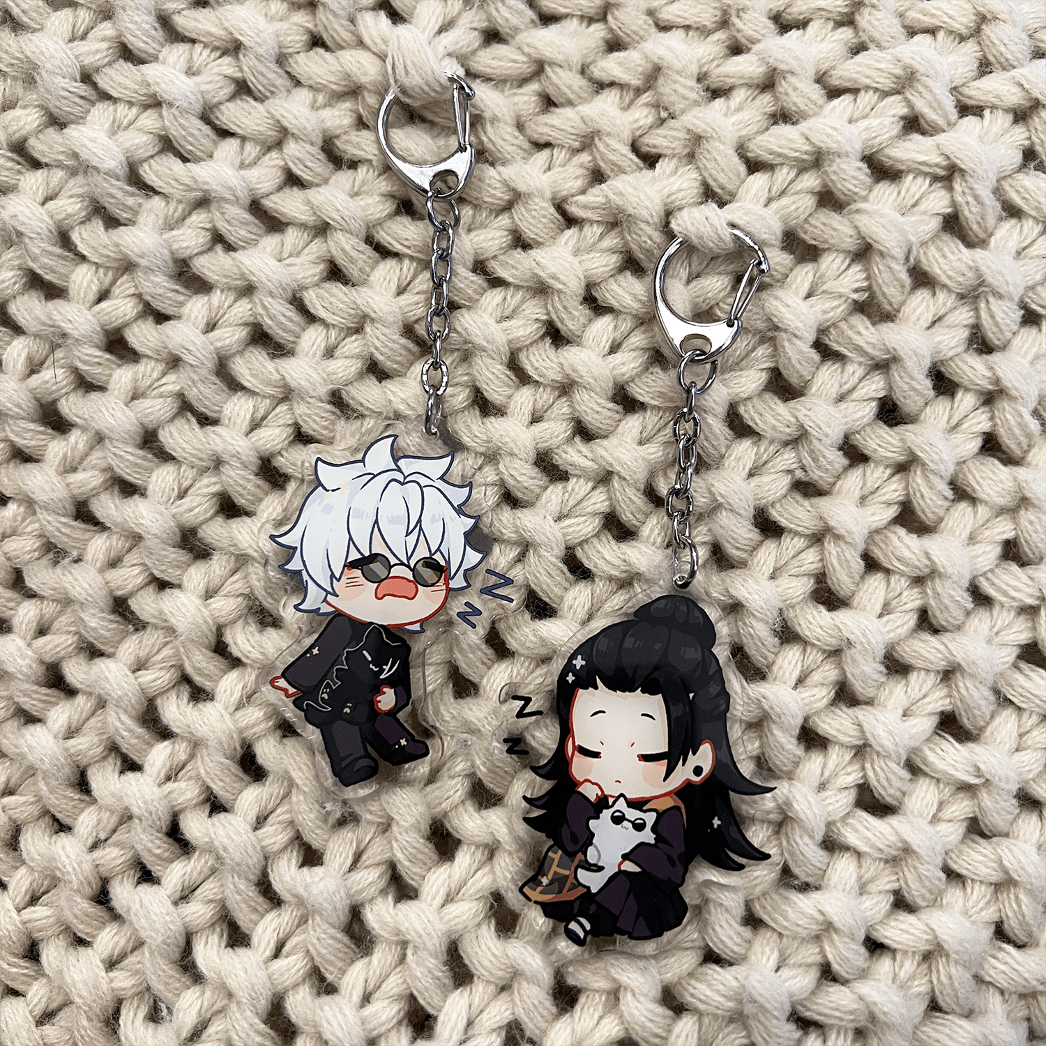 2 clear anime acrylic keychains next to each other featuring geto suguru holding cat gojo and gojo satoru holding cat suguru jujutsu kaisen keychain bundle set