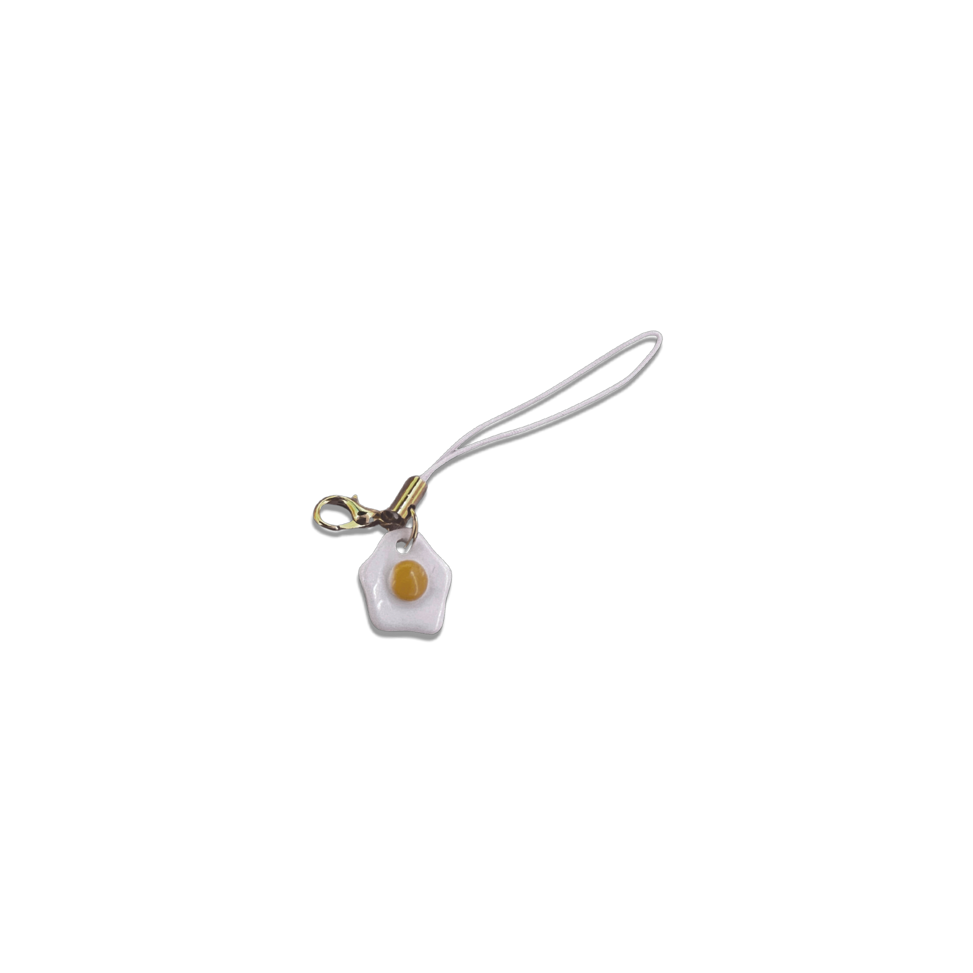 Small egg charm on a basic white phone strap.