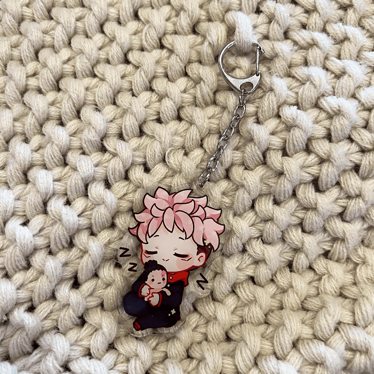 clear acrylic keychain featuring yuji itadori from jujutsu kaisen sleeping hugging best friend todo plushie