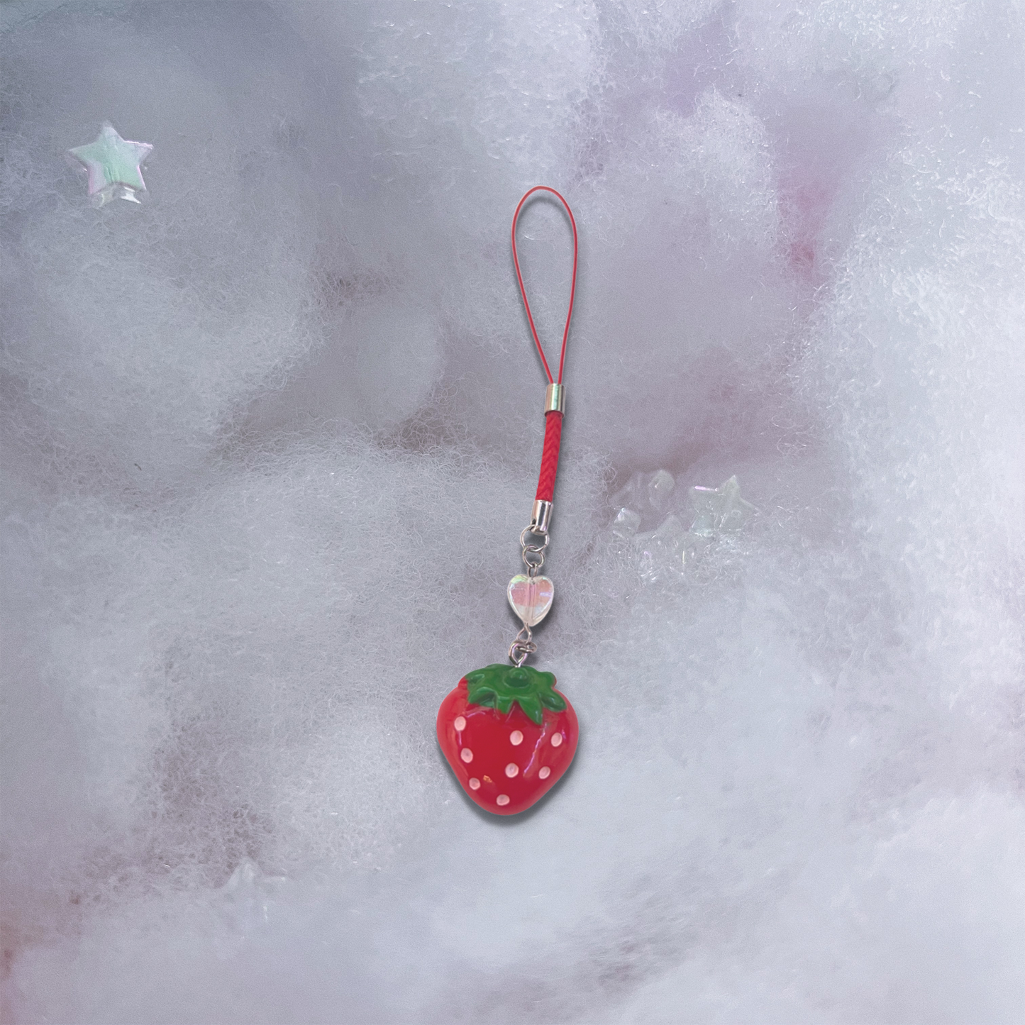 Red strawberry charm with holographic heart bead and red braided phone strap.