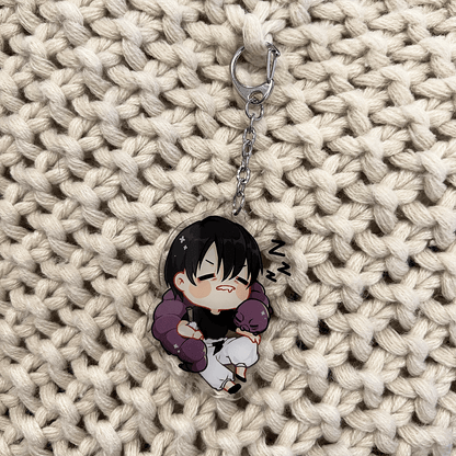 clear acrylic anime keychain featuring sleeping toji fushiguro from jujutsu kaisen with cursed object wrapped around him sleeping
