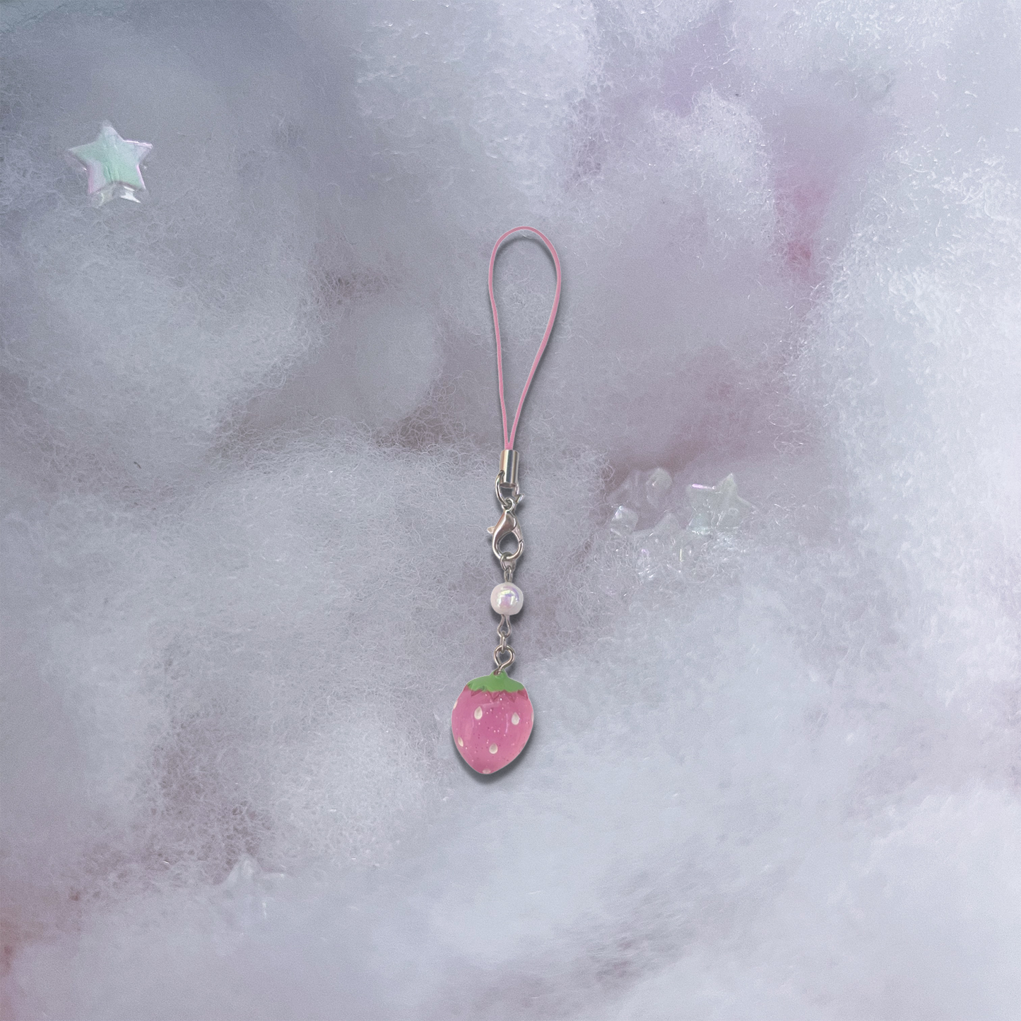Small pink strawberry charm with pearlescent bead and basic pink phone strap.