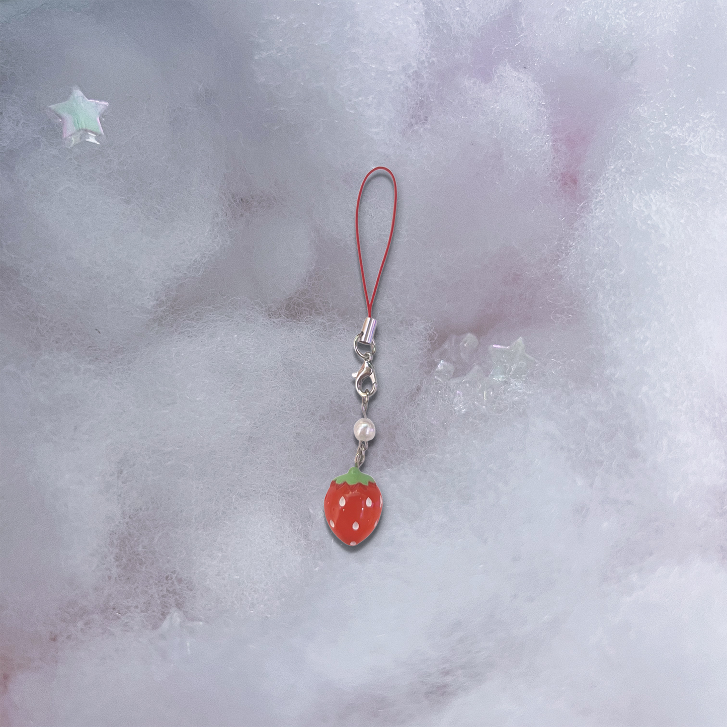 Small red strawberry charm with pearlescent bead and basic red phone strap.