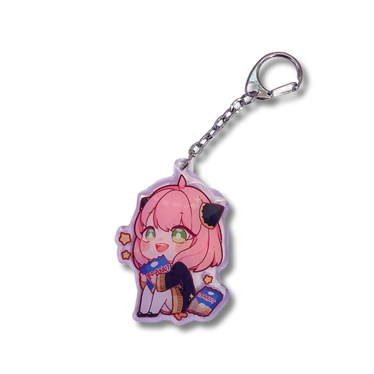 Anya Peanuts Acrylic Keychain features Anya Forger from Spy x Family holding a bag of peanuts in a sitting position.