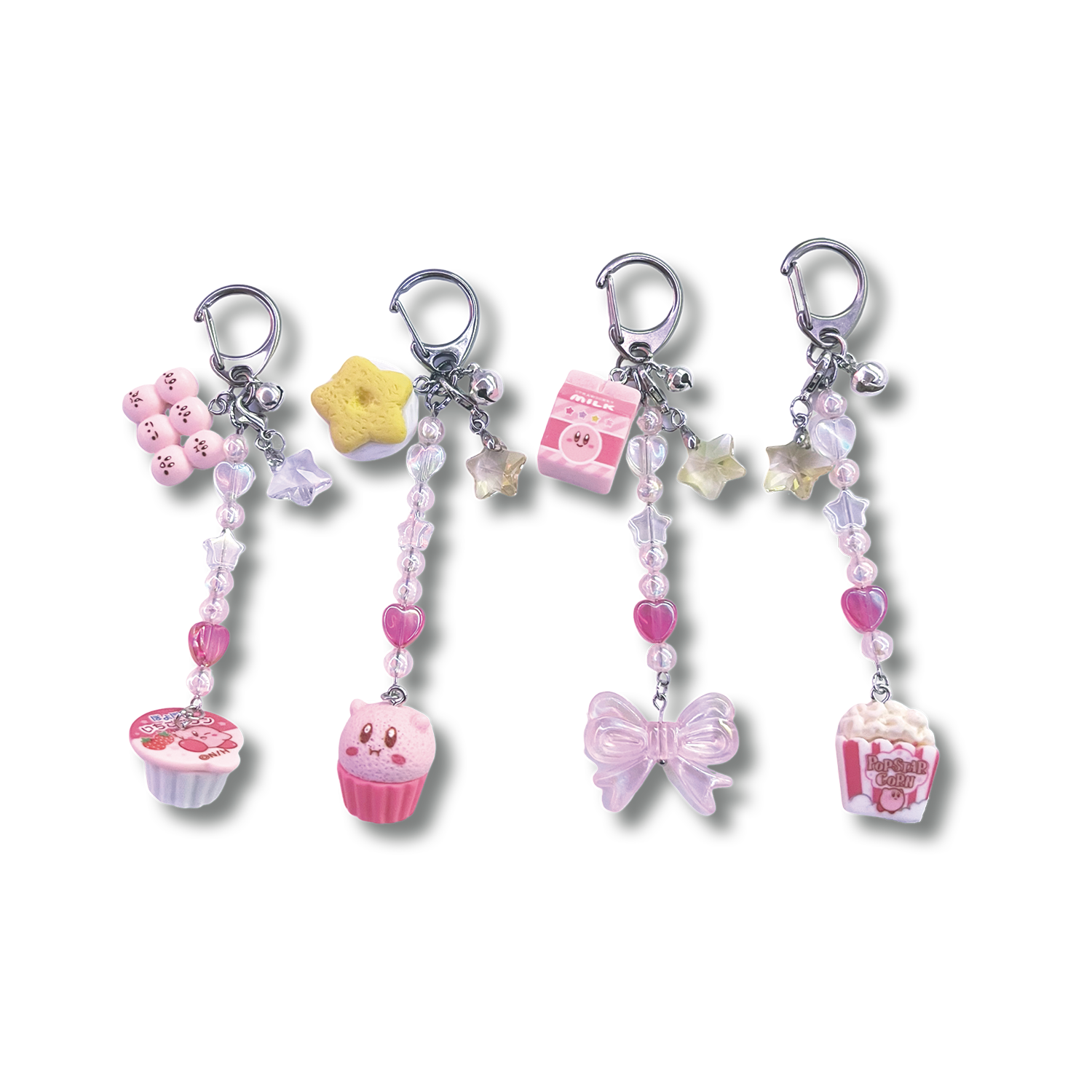 4 different assorted kirby keychains are pictured left to right, with the first one featuring a Kirby coffee creamer, second one is a Kirby cupcake, third is a Kirby milk carton, and fourth and last one is Kirby popcorn, all arranged respectively.