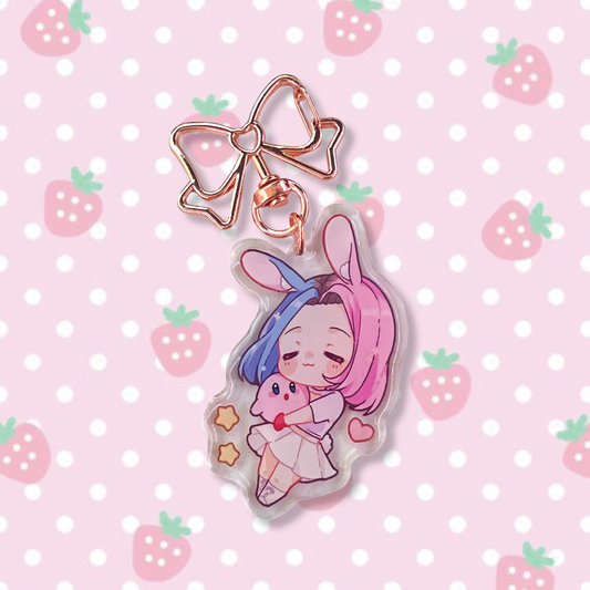 Usagi-Chan Chibi Keychain design features Usagi x Usagi's mascot Usagi-Chan holding a Kirby plushy, in a heart cut-out top and white skirt outfit, in a sparkly acrylic keychain finish with a golden bow hook.